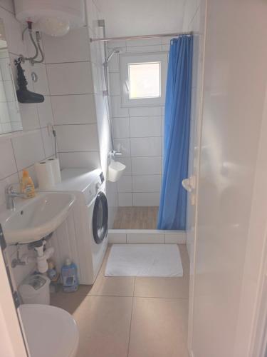 a bathroom with a washing machine and a sink at Apartman deluxe sea in Split