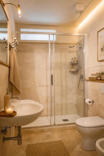 a bathroom with a shower and a sink and a toilet at Ginevra Suite in Cortona