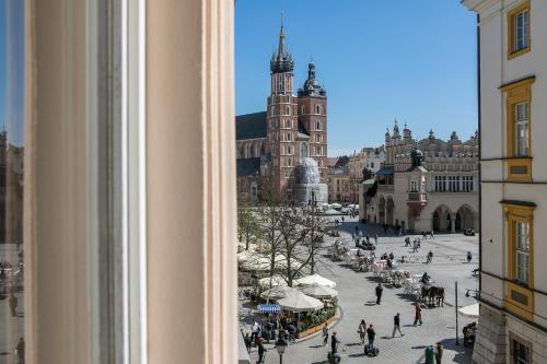 a view of a city street from a window at Cracow Main Square Apartments in Krakow