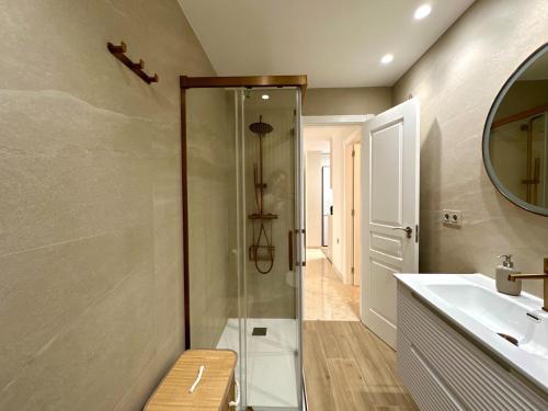 a bathroom with a glass shower and a sink at Twin Beach in Torrenueva