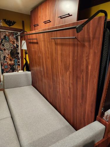 a wooden door with two seats in a room at Snugnuff in South Burlington