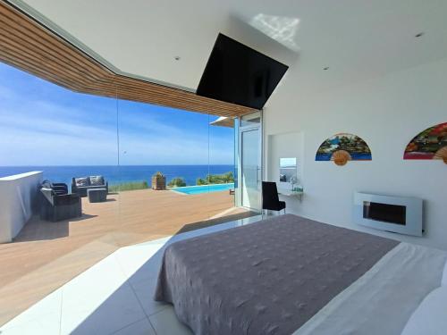 a bedroom with a bed and a view of the ocean at Villa Luxury Paradise in Salobreña