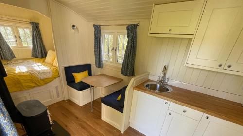a small kitchen with a sink and a bed at The Shepherds Hut in Wallingford