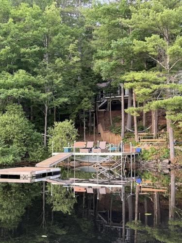 a dock in the middle of a lake with trees at HOLIDAY COVE - LIMIT 8 villa in Naples