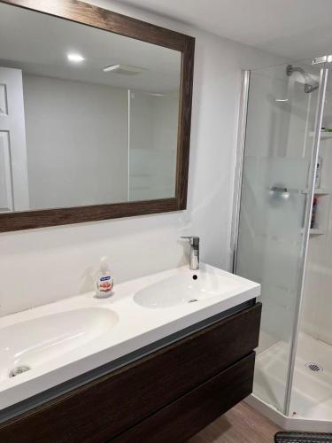a bathroom with a white sink and a shower at Bright Spacious Room-3B in Halifax