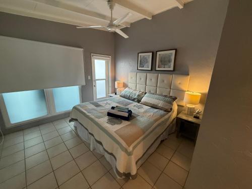 a bedroom with a large bed and two windows at Sea Crest in Sarasota