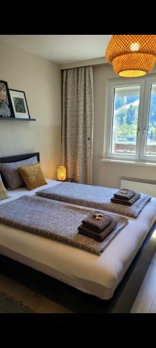 a bedroom with a large bed with towels on it at Sunrise Apartment in Schladming