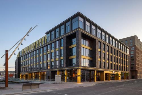 a large office building with a lot of windows at Aloft by Marriott Belfast Titanic Quarter in Belfast