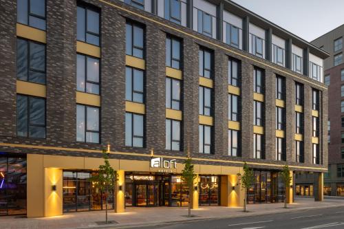 an apartment building on a city street at Aloft by Marriott Belfast Titanic Quarter in Belfast