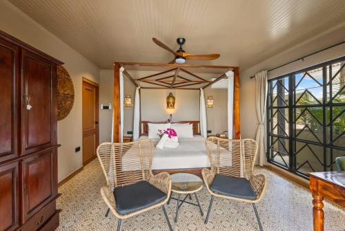a bedroom with a table and chairs and a bed at Bali Suites - Sanur suite in Willemstad