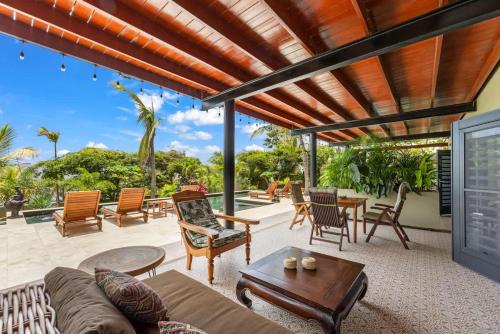 an outdoor living room with a couch and a table at Bali Suites - Sanur suite in Willemstad