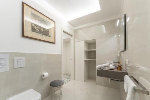 a white bathroom with a sink and a toilet at Villa Anna in Meta