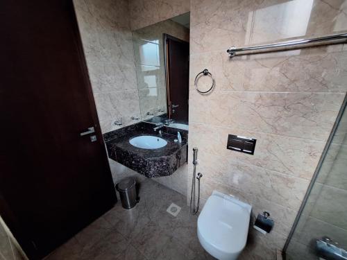 a bathroom with a sink and a toilet at Aspire Tower in Manama