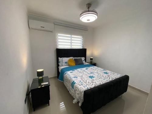 a bedroom with a large bed and a window at Beautiful View Apartment in San Pedro de Macorís