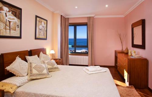 a bedroom with a bed with a view of the ocean at Villa Rosal in Oia