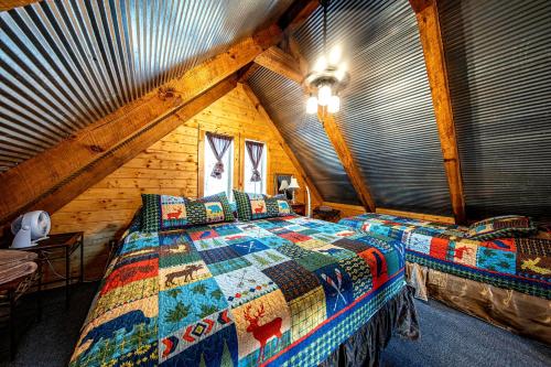 a bedroom with a bed in a wooden attic at Riverview Cabin in Helen