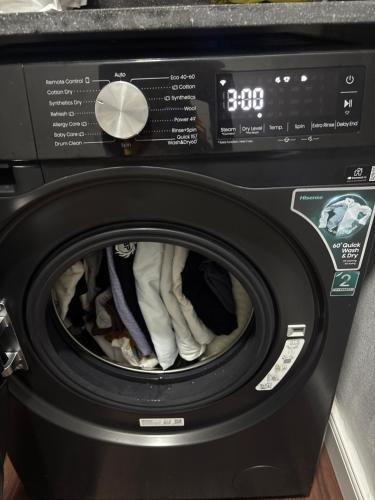a black washing machine with its door open at Alexa Smart Home One Bedroom Luxury Apartment in Lekki