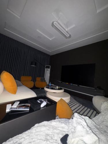 a room with two beds and a flat screen tv at Alexa Smart Home One Bedroom Luxury Apartment in Lekki