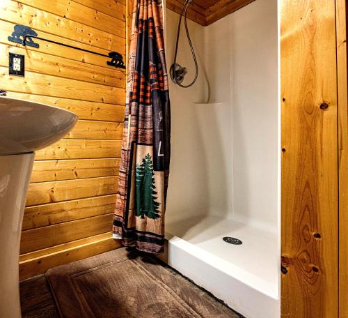 a bathroom with a shower curtain next to a sink at Riverview Cabin in Helen