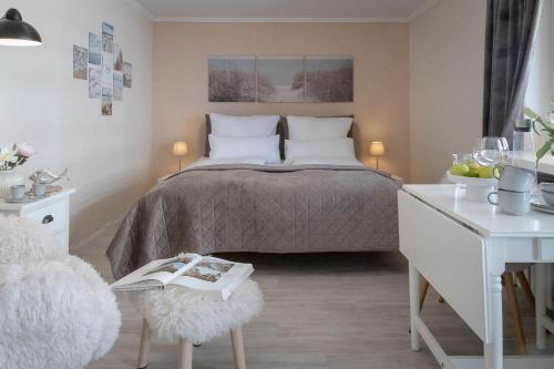 a bedroom with a bed and a table with a book at Hein Wichtig in Boostedt