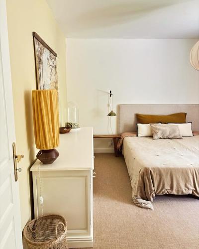 a bedroom with a bed and a table with a lamp at Luxury family villa with large pool, garden & outdoor dining near beach, Domaine l'Oiseau Bleu in Sainte-Maxime in Sainte-Maxime