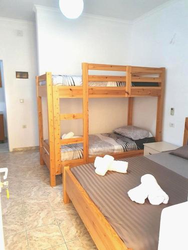 two bunk beds in a room with two hats at Beautiful Sea View Borsh in Borsh