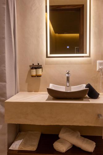 a bathroom with a sink and a mirror at 7 Casa Laurel Hotel Boutique in Oaxaca City