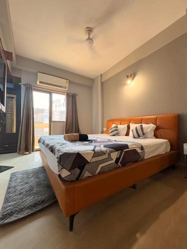 a bedroom with a large bed in a room at Hare Krishna Orchid Society in Vrindāvan