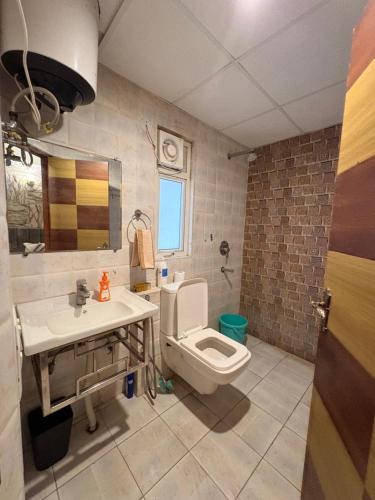 a bathroom with a toilet and a sink at Hare Krishna Orchid Society in Vrindāvan
