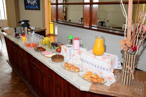 a table with food on a counter in a kitchen at Ibiza Hostel Suites in Santa Cruz de la Sierra
