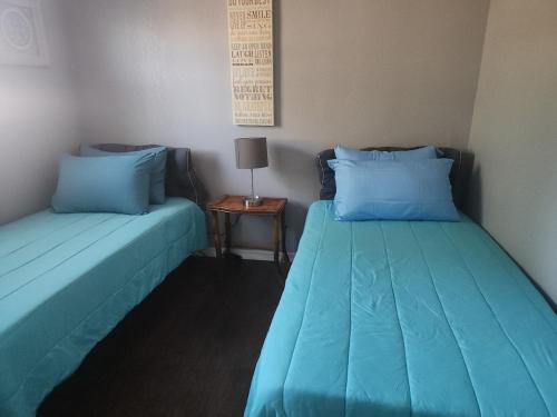 two beds sitting next to each other in a room at Whole House All Yours! in Cocoa