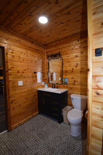 a wooden bathroom with a toilet and a sink at Nisqually Lodge in Ashford
