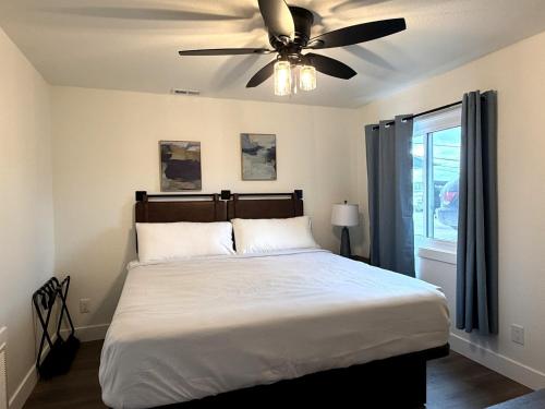 a bedroom with a bed with a ceiling fan at Alhonna Resort in Lake Ozark