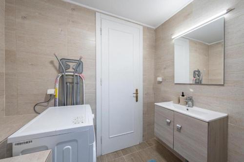 a bathroom with a sink and a white door at Santa Decca in Áyioi Dhéka