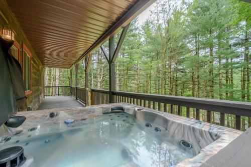 a jacuzzi tub on a deck in the woods at 1 Kingfisher in Blowing Rock