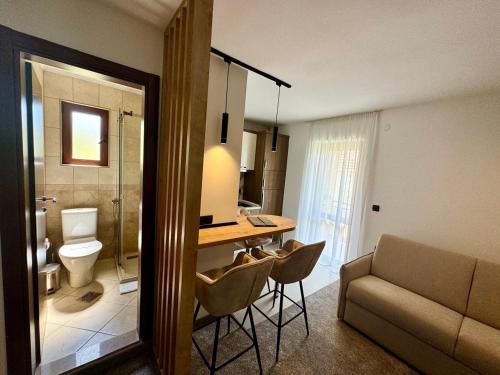 a room with a bathroom with a desk and a couch at Apartments Jovanovic - Alkima in Kotor