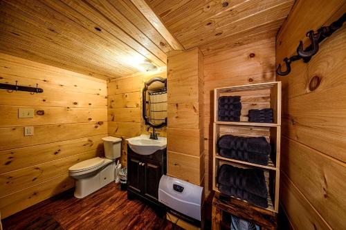 a wooden bathroom with a toilet and a sink at Log Cabin in Helen
