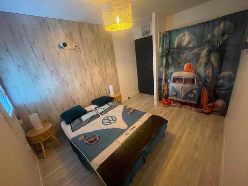 a bedroom with a large bed with a painting on the wall at Silver in Quessoy