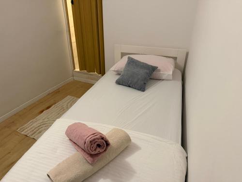 two beds with towels on them in a room at Luxury rooms in Split