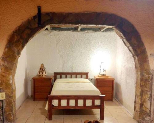 a bedroom with a bed and two night stands at Quinta Rancho Pingos in General Rodríguez
