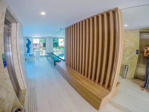 a hallway with a wooden wall in a building at Freitas Residence - Quinta Manuel Rodrigues in Recife