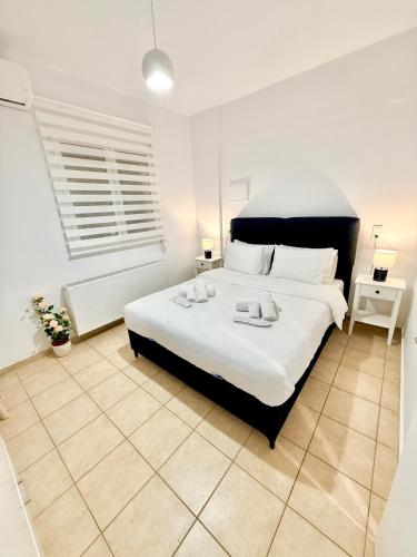 a bedroom with a large white bed in a room at Archanes Cozy Retreat in Archanes