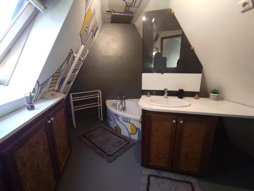 a bathroom with a sink and a mirror at Mon petit chalet in Puycornet