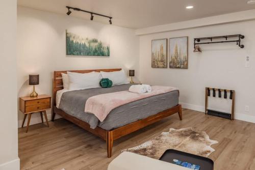 a bedroom with a large bed and a table with a couch at Modern Studio Downtown Anchorage in Anchorage