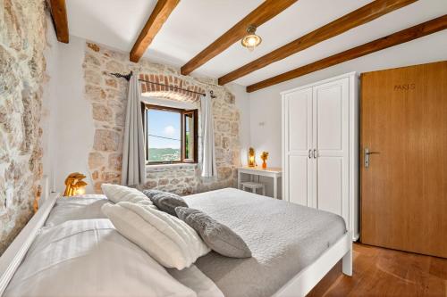 a bedroom with a white bed and a window at Villa Stone-Exceptional private Estate in Mlini
