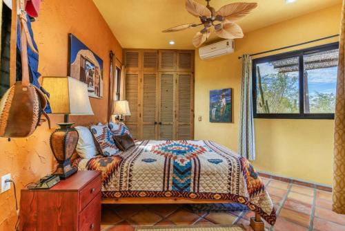 a bedroom with a bed and a ceiling fan at Casa Silverado in Buenavista
