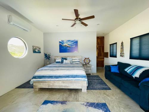 a bedroom with a bed and a couch at Sunny Poolside Escape Near the Beach in Los Barriles