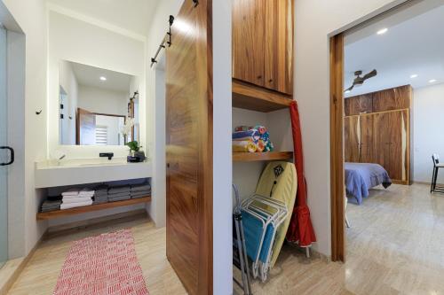a bathroom with a sink and a bathroom with a mirror at Seize the Day at Carpe Diem Condo in Los Barriles