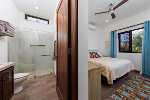 a bedroom with a bed and a bathroom with a shower at Pool with a View in Buena Vista in Buenavista