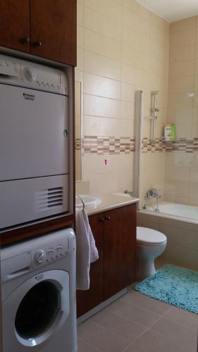 a bathroom with a washing machine and a sink at Acropolis Sea View Villa in Polis Chrysochous
